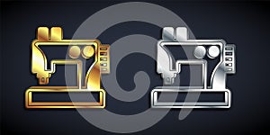 Gold and silver Sewing machine icon isolated on black background. Long shadow style. Vector