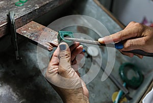Gold smith making a ring' s wax mold,