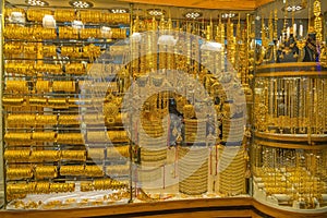 Gold souk with golden pieces of jewelry in Dubai, UAE