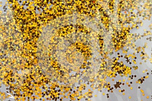 Gold sparkle glitter background. Glittering sequins stars wall