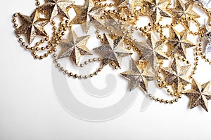 Gold star and bead garland on white backgroun. Flat lay.  Top view