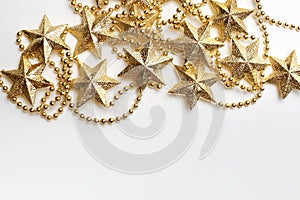 Gold star and bead garland on white backgroun. Flat lay.  Top view