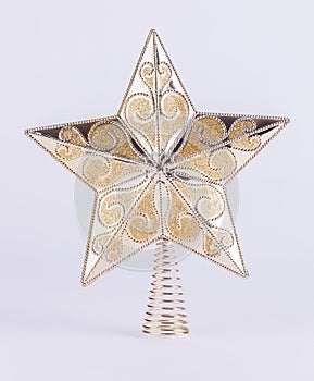 Gold star Christmas tree decoration on white background photo