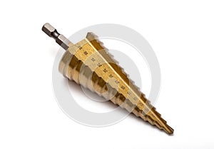 Gold step drill for drilling holes of different diameters, close-up. Professional