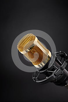 Gold studio microphone on black
