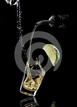 Gold Tequila Pouring into Shot Glass