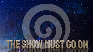 Gold text the show must go on for present background photo