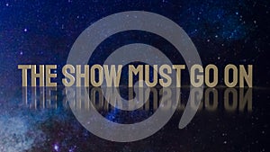 Gold text the show must go on for present background photo
