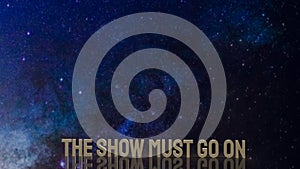 Gold text the show must go on for present background photo