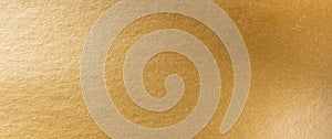 Gold texture background. Golden shiny foil paper panorama. Soft shine gradient reflection