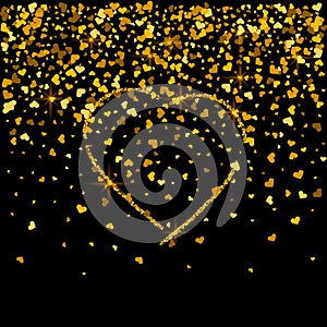 Gold texture of glitter in the shape of heart on a black background. Holiday background. Golden grainy abstract texture