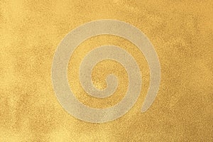 Gold textured surface background with light reflections