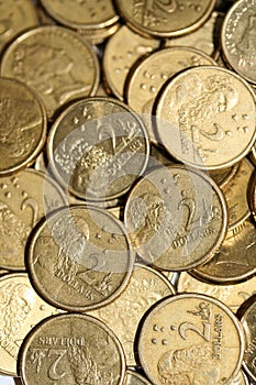 Gold two dollar coins scattered