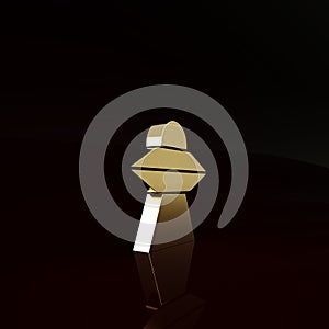 Gold UFO flying spaceship icon isolated on brown background. Flying saucer. Alien space ship. Futuristic unknown flying