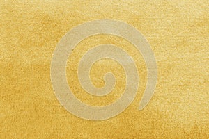 Gold velvet background or golden yellow velour flannel texture made of cotton or wool with soft fluffy velvety satin photo