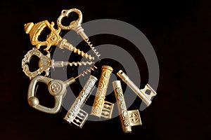 Gold vintage corkscrews on a black background