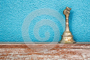 Gold vintage retro bell on wooden table