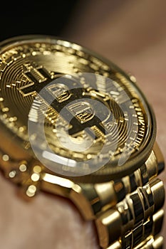 Gold watch with bitcoin symbol