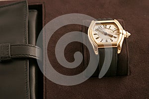 Gold watch with black strap