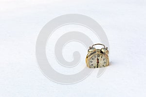 a gold watch on a pure white snow