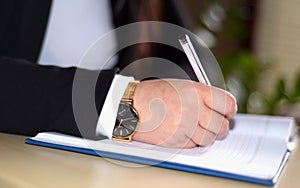 A gold watch on a woman's hand