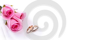 Gold wedding ring and rose flower bouquet. Wedding horizontal background