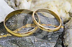 Gold wedding ring on the stone