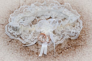 Gold wedding rings on a background garters bride in day