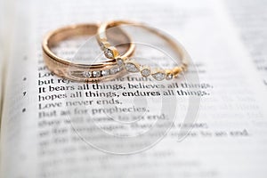 Gold Wedding rings on Bible verse, Love Never Fails