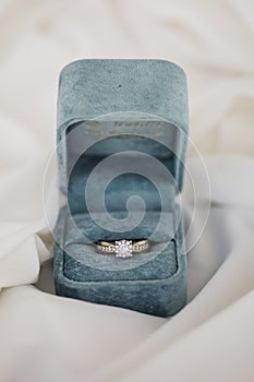 Gold wedding rings in box. Ring with diamonds