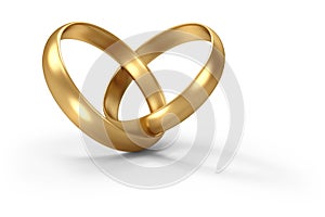 Gold wedding rings linked in shape of heart