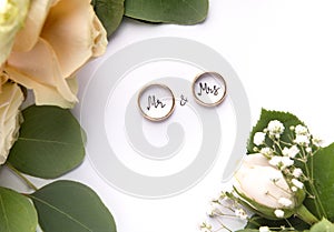 Gold Wedding rings with mr and mrs text inside on white