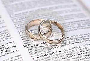 Gold wedding rings on a page showing love