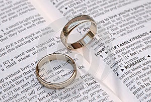 Gold wedding rings on a page showing love