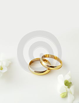 Gold wedding rings with small flowers on off white background Wedding invitation card generative ai illustration