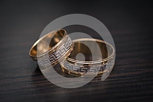 Gold wedding rings on wooden box.