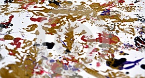 Gold white black blue red paint blurred spots abstract background