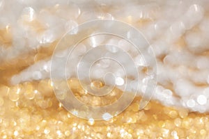 Gold and white shiny festive background. Shiny golden and silver glitter, sparkles, bokeh lights