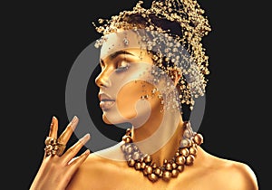 Gold woman skin. Beauty fashion model girl with golden makeup