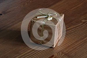 Gold wrapped gift on wood