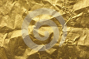 Gold wrinkled paper texture abstract background