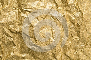 Gold wrinkled paper texture abstract background