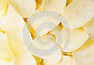 Gold yellow crispy potato chips snack texture background - potato chips background, teasty food photo