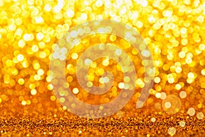 Gold yellow glitter foil background. Shiny metal gold foil texture abstract defocused background. Sparkle glitter texture with