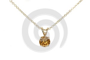 Gold Zircon pendant, silver chain. White background.