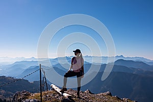 Goldeck - Active hiker woman looking at magical mountain peaks of Karawanks and Julian Alps seen from Goldeck, Latschur group