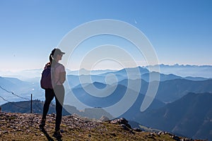 Goldeck - Active hiker woman looking at magical mountain peaks of Karawanks and Julian Alps seen from Goldeck, Latschur group