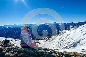 Goldeck - A girl admiring the snowy mountains