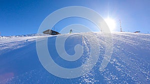 Goldeck - A skier going down the groomed slope
