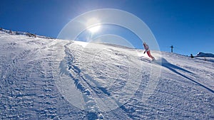 Goldeck - A snowboarding girl going down the slope